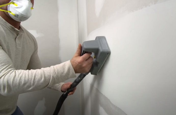 sanding the installed drywall