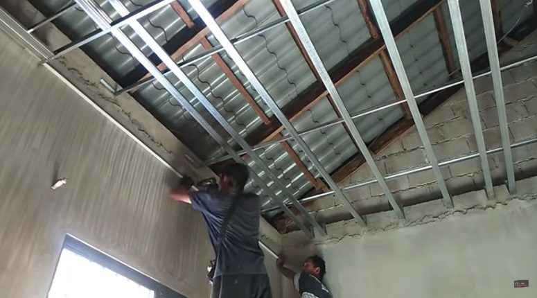 workers installing drywall for ceiling